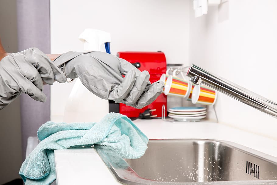 woman wearing gloves for washing dishes