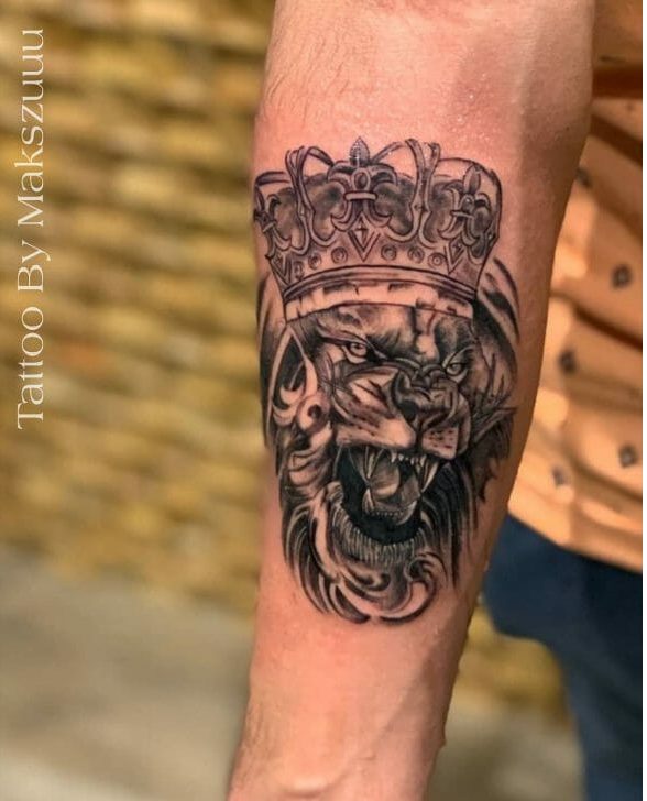 lion tattoo on forearm with crown