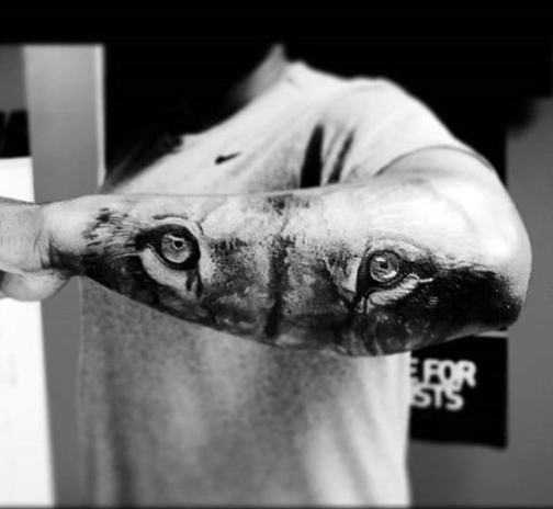 lion eye tattoo on forearm
