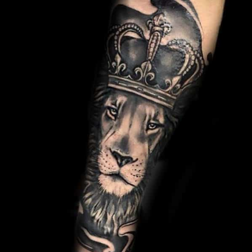 crowned lion tattoo on forearm